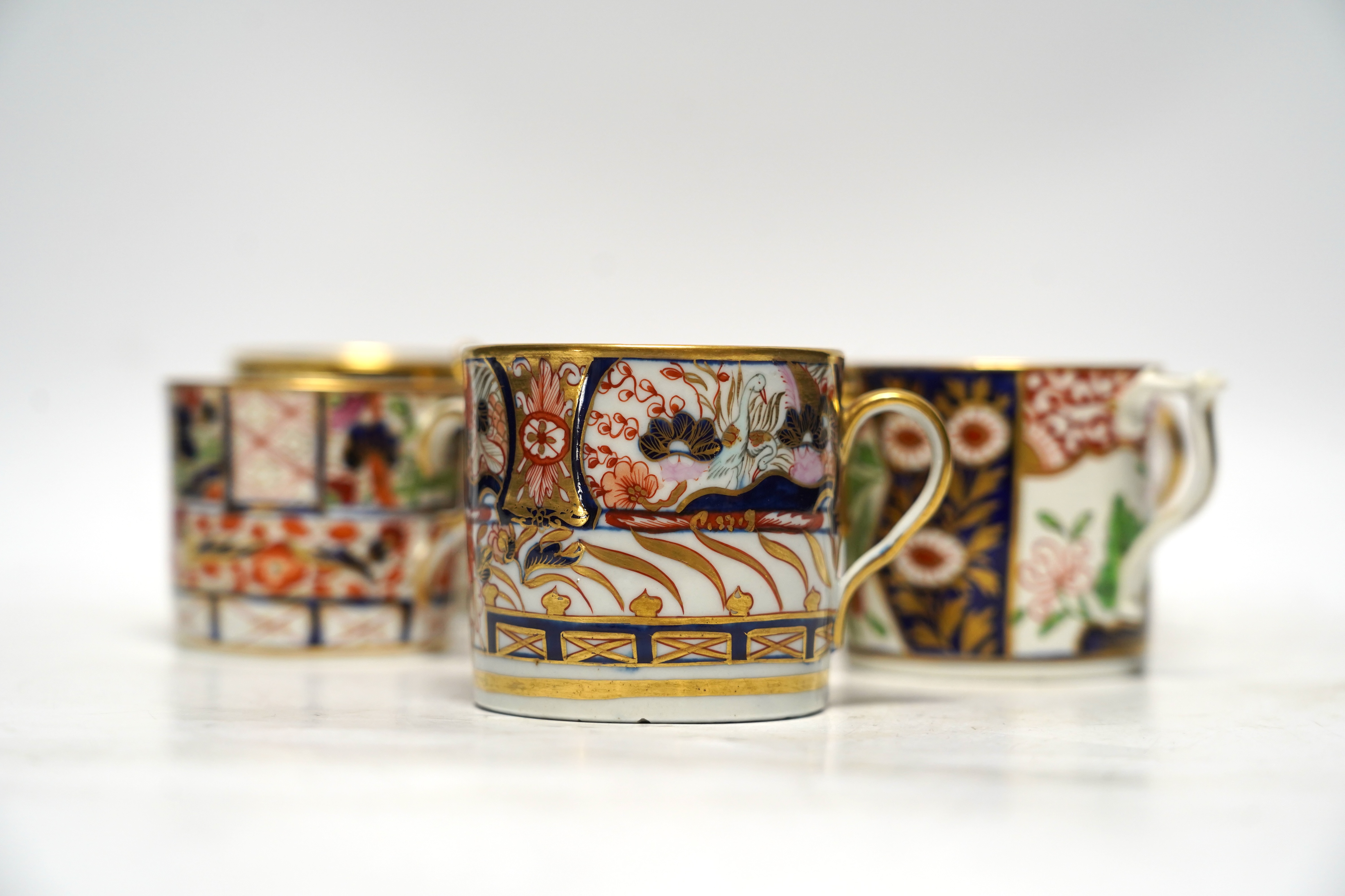 Seven 1800-1820 English porcelain coffee cans, including Imari pattern examples